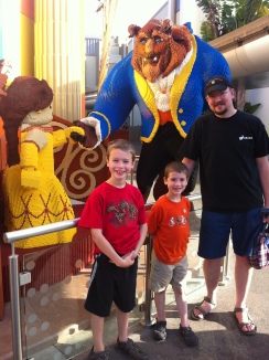 At the Lego store at Downtown Disney (and, yes, he's holding my purse because it was heavy).