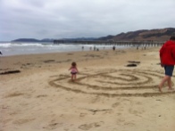 Walking a sand labyrinth with daddy.